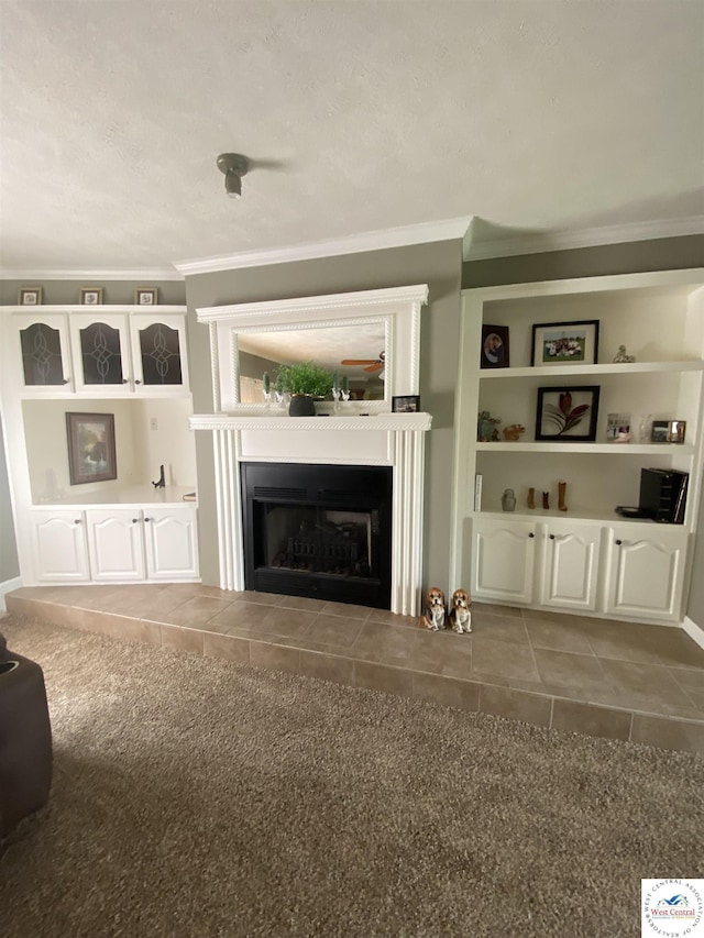 715 Ww Hwy, Osceola, MO 64776 - unfurnished living room with ornamental molding, a fireplace, tile patterned flooring, built in shelves, and carpet