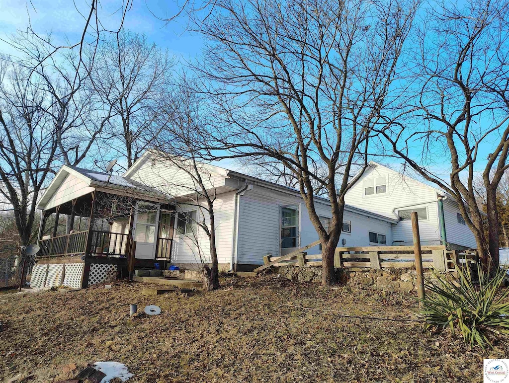 view of side of home with a sunroom