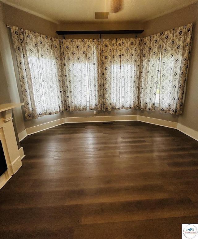902 N 2nd St, Clinton, MO 64735 - unfurnished room with wood finished floors, baseboards, and a fireplace