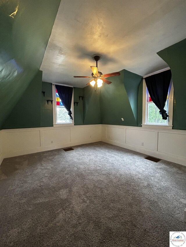 902 N 2nd St, Clinton, MO 64735 - bonus room featuring ceiling fan, carpet, a decorative wall, wainscoting, and vaulted ceiling