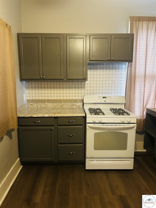 902 N 2nd St, Clinton, MO 64735 - kitchen with gas range gas stove, dark wood finished floors, tasteful backsplash, baseboards, and gray cabinets