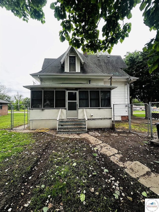 902 N 2nd St, Clinton, MO 64735 - rear view of house featuring a gate, a sunroom, and entry steps