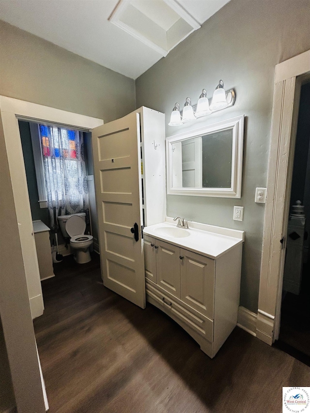 902 N 2nd St, Clinton, MO 64735 - bathroom with vanity, wood finished floors, and toilet