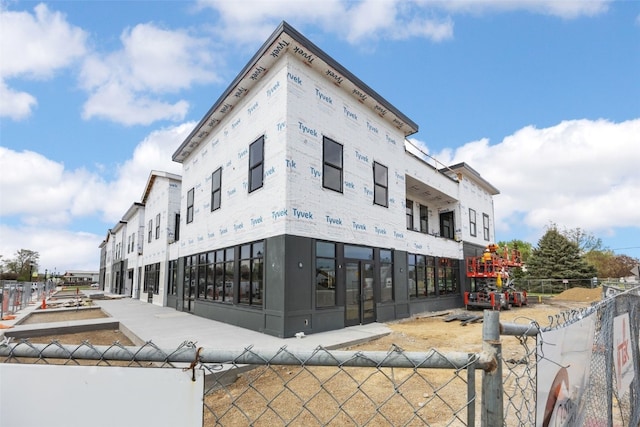 view of building exterior featuring fence
