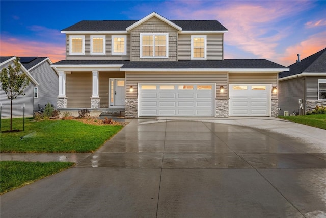 view of front of house featuring a lawn and a garage