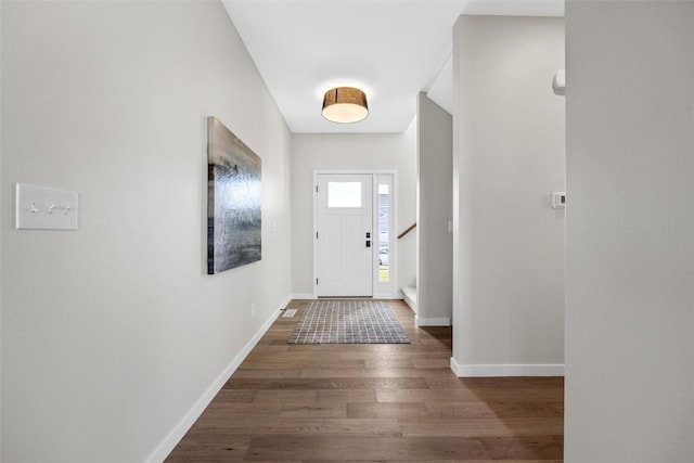 entryway with dark hardwood / wood-style flooring