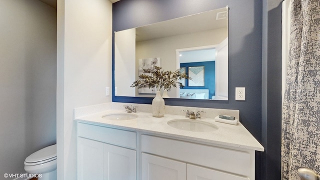 bathroom featuring vanity and toilet