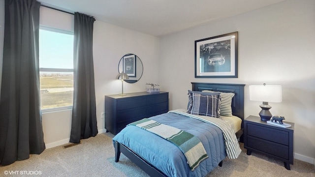 bedroom with light colored carpet