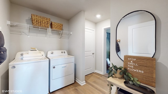 washroom with light wood-type flooring and washer and dryer