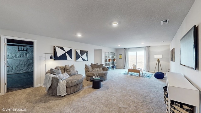 living room featuring carpet and a textured ceiling