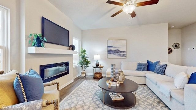 608 Maddie Ln, Tiffin, IA 52340 - living area with a ceiling fan, a glass covered fireplace, baseboards, and wood finished floors