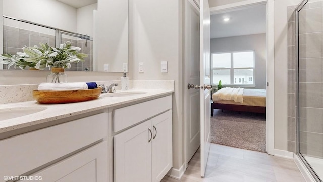 608 Maddie Ln, Tiffin, IA 52340 - ensuite bathroom with double vanity, a sink, a stall shower, and ensuite bath