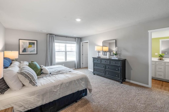 carpeted bedroom featuring ensuite bathroom