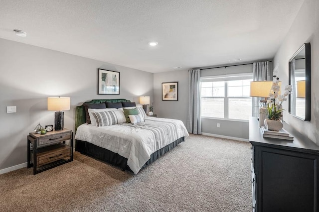 bedroom with a textured ceiling and carpet floors