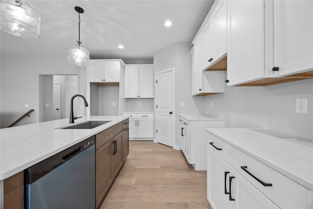 kitchen with light stone countertops, sink, light hardwood / wood-style floors, stainless steel dishwasher, and white cabinets