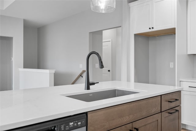 kitchen with white cabinetry, dishwasher, sink, and pendant lighting