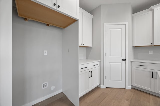 kitchen featuring white cabinetry and light hardwood / wood-style floors