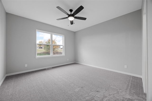 carpeted empty room with ceiling fan