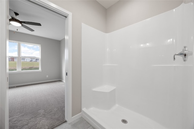 bathroom featuring ceiling fan and walk in shower