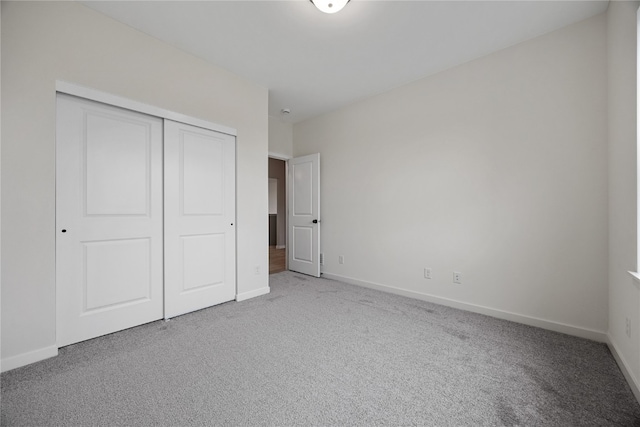 unfurnished bedroom with a closet and carpet floors