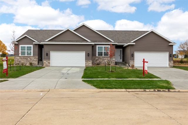 craftsman-style home with a front lawn and a garage