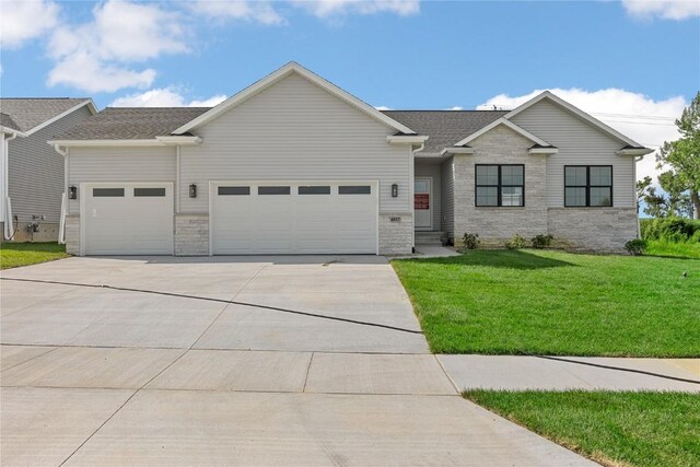 view of front of home featuring a garage and a front yard