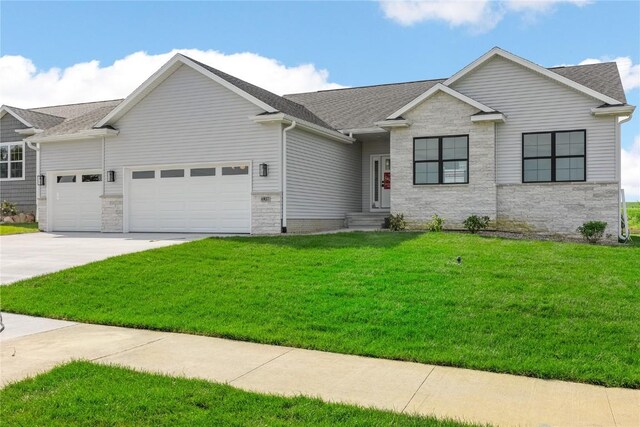 view of front of home featuring a garage and a front yard