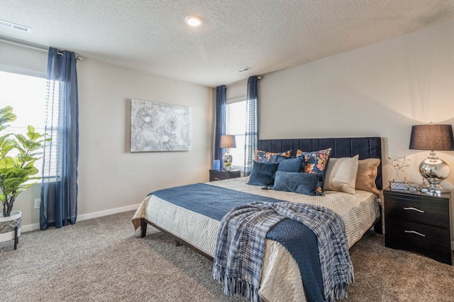 carpeted bedroom with a textured ceiling