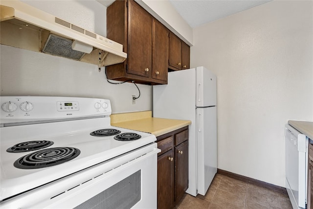 kitchen featuring white appliances, tile floors, ventilation hood, and dark brown cabinetry