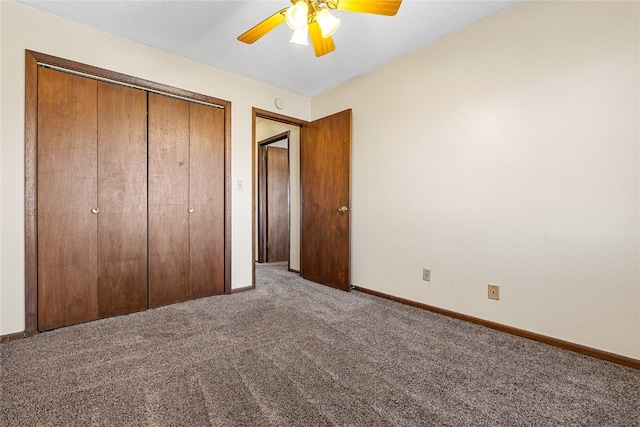 unfurnished bedroom with ceiling fan, a closet, and dark carpet