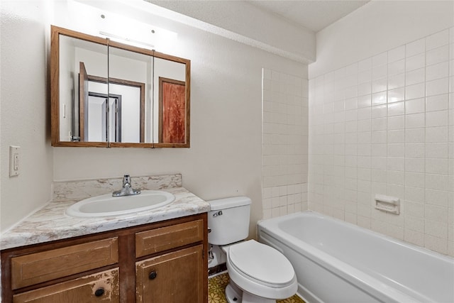 full bathroom featuring vanity with extensive cabinet space, toilet, and tiled shower / bath