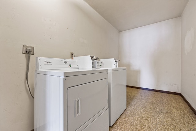 clothes washing area featuring washing machine and dryer, electric dryer hookup, and light carpet