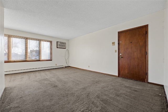 spare room with a textured ceiling, dark carpet, a baseboard radiator, and a wall mounted AC