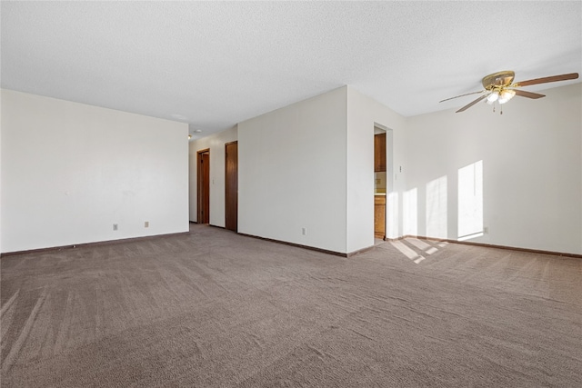 carpeted empty room with ceiling fan and a textured ceiling