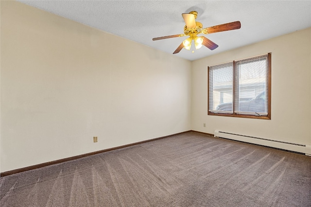 spare room with ceiling fan, dark carpet, and a baseboard heating unit