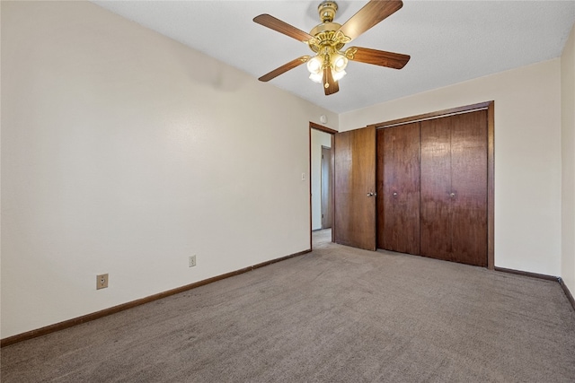 unfurnished bedroom with ceiling fan, light colored carpet, and a closet