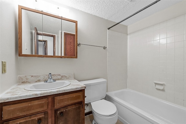 full bathroom with a textured ceiling, tiled shower / bath, toilet, and vanity