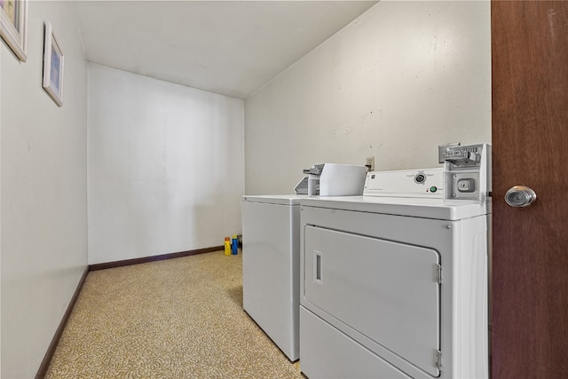 laundry room with washing machine and clothes dryer and light colored carpet