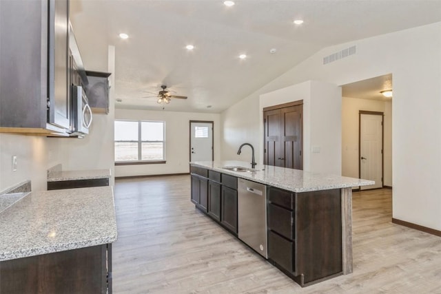 kitchen with visible vents, dark brown cabinetry, a center island with sink, appliances with stainless steel finishes, and a sink