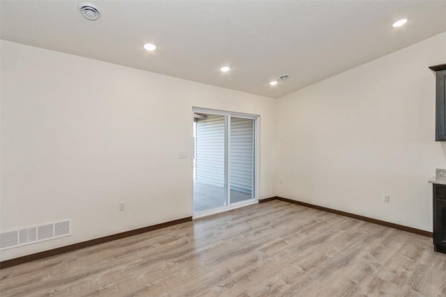 spare room featuring visible vents, recessed lighting, light wood-type flooring, and baseboards