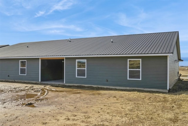 back of house featuring metal roof and a patio area