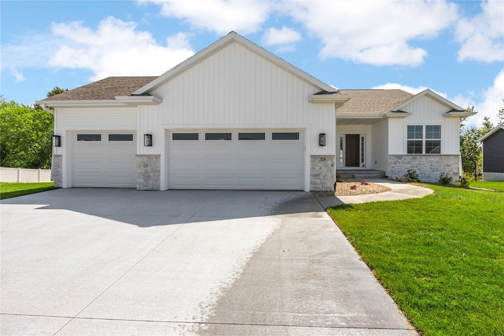 view of front facade with a garage and a front lawn