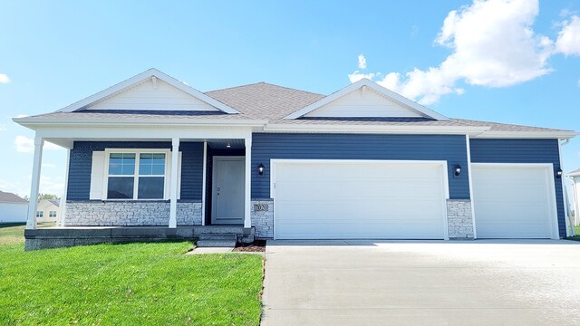 view of front facade with a front yard and a garage