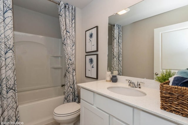 full bath with toilet, vanity, and shower / bath combo