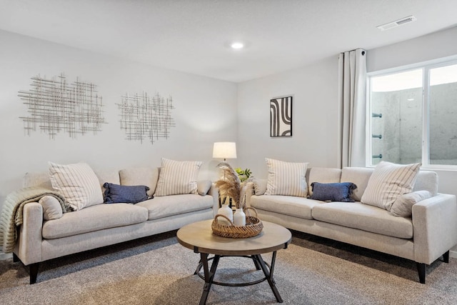 carpeted living area with recessed lighting and visible vents