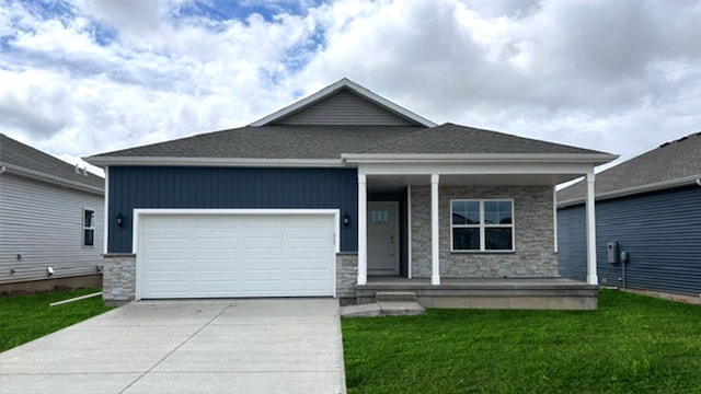 ranch-style home with a porch, a front yard, driveway, stone siding, and an attached garage