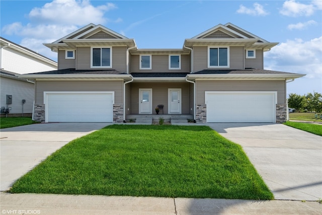 view of front of house with a front yard and a garage