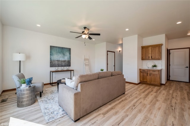 living room featuring ceiling fan and light wood-type flooring