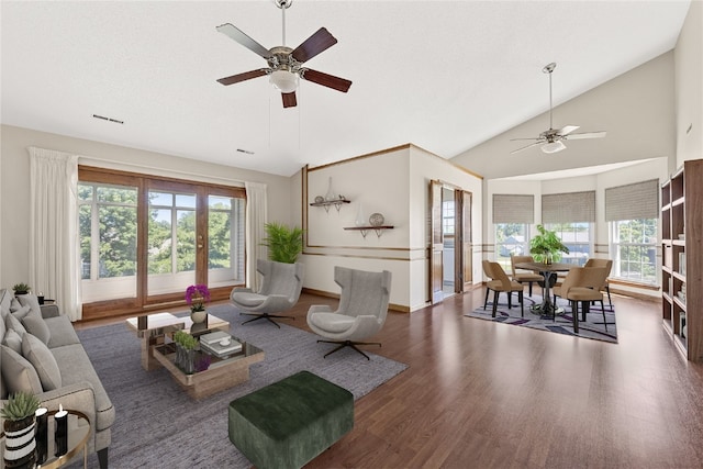 living room with dark hardwood / wood-style floors, ceiling fan, and a wealth of natural light