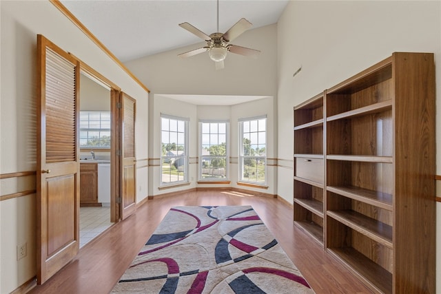 interior space with high vaulted ceiling, tile flooring, and ceiling fan